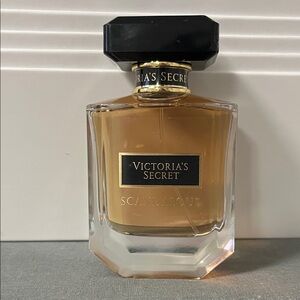 Victoria's Secret Scandalous Perfume with Black Cap and Gold Hue